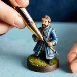 피규어 도색 도구 선택 팁 - **Prompt:** A close-up, high-detail shot of a skilled miniature painter, of ambiguous gender, focuse...